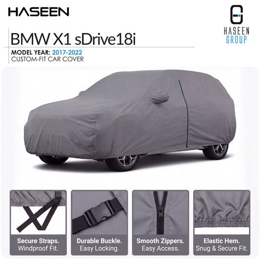 A gray custom-fit car cover shown on a BMW X1 sDrive18i, with HASEEN branding and feature callout panels at the bottom describing secure straps, durable buckle, smooth zippers, and elastic hem.