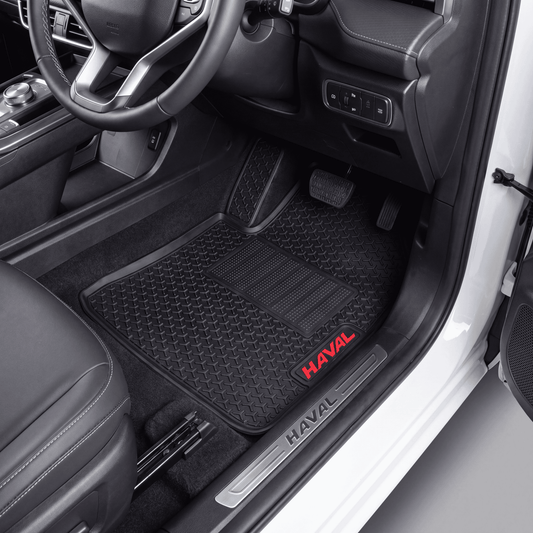 Black textured car floor mats installed in a vehicle interior, with red HAVAL logos on the front mats and a silver HAVAL door sill.