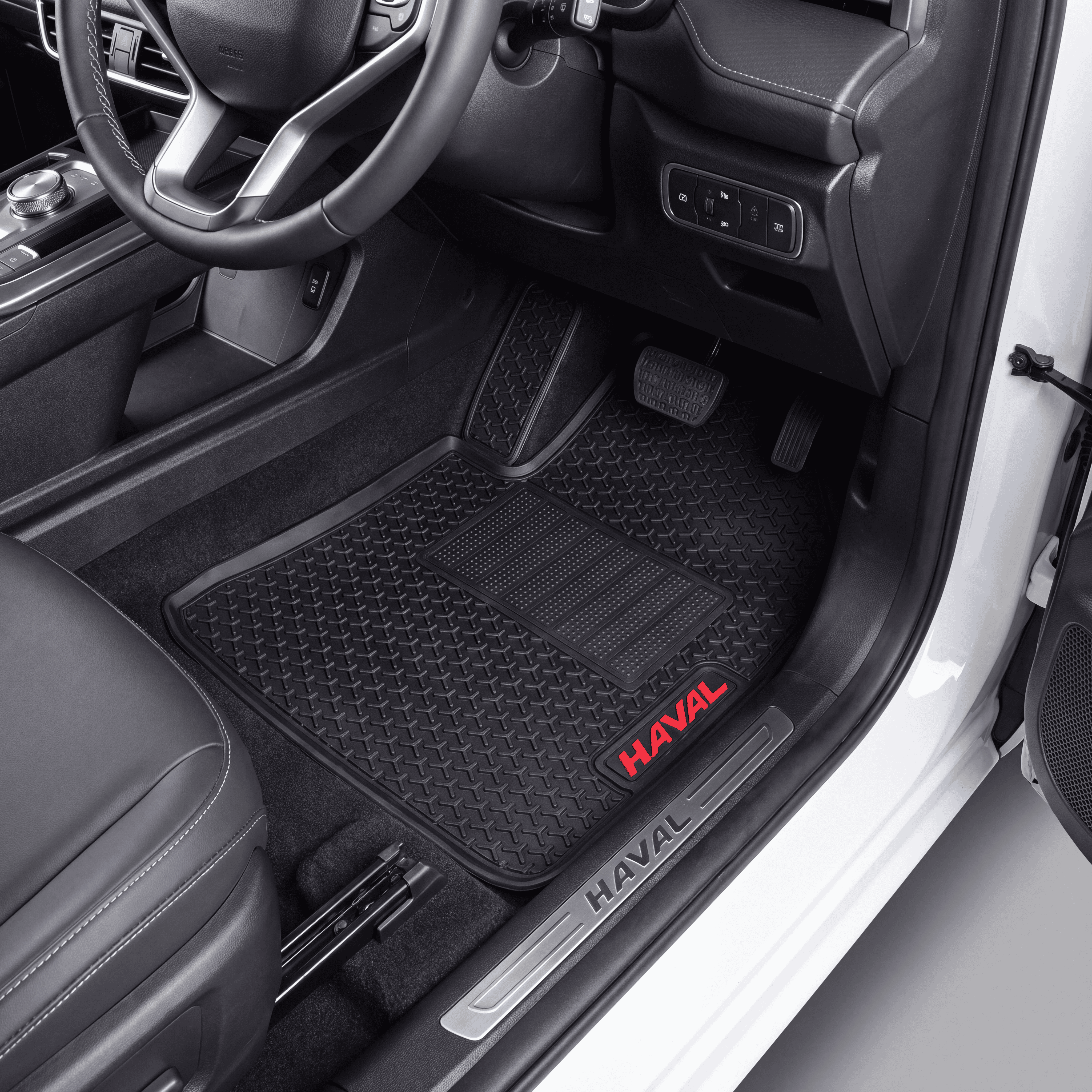 Black textured car floor mats installed in a vehicle interior, with red HAVAL logos on the front mats and a silver HAVAL door sill.