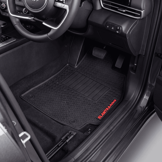 Black textured car floor mats installed in a vehicle's front cabin, with the driver's side mat showing a red ELANTAI-Pro logo near the threshold.