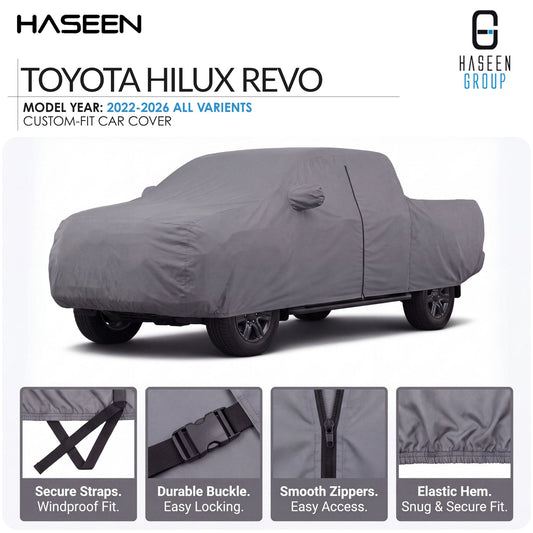 A gray custom-fit car cover shown on a Toyota Hilux Revo vehicle, with HASEEN branding and four feature callout panels at the bottom highlighting secure straps, durable buckle, smooth zippers, and elastic hem.
