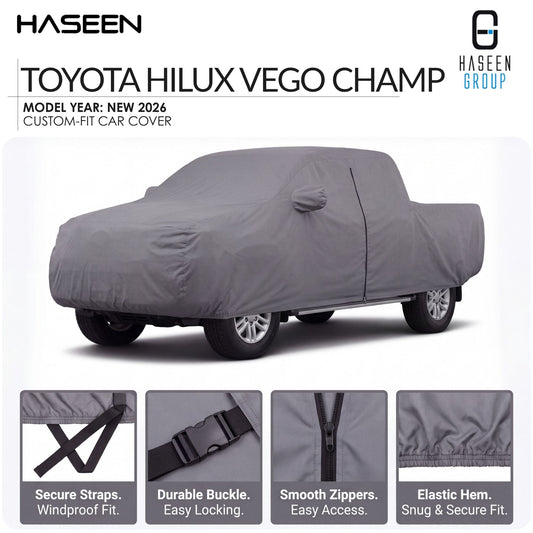 A gray custom-fit car cover shown on a Toyota Hilux pickup truck against a white background, with HASEEN branding and feature callouts below. The text specifies 'TOYOTA HILUX VEGO CHAMP' and 'MODEL YEAR: NEW 2026'.