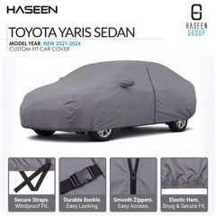 A gray car cover fitted over a Toyota Yaris sedan, shown on a white background with HASEEN branding and feature callout panels at the bottom describing secure straps, durable buckle, smooth zippers, and elastic hem.