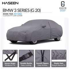 A gray custom-fit car cover shown on a BMW 3 Series (G 20) model car, with HASEEN branding and feature callouts along the bottom highlighting secure straps, durable buckle, smooth zippers, and elastic hem.
