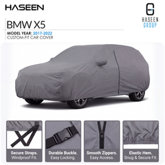 A gray custom-fit car cover shown on a white background, with the text 'BMW X5' and 'Model Year: 2017-2022' at top left, the Haseen Group logo at top right, and four feature callout panels along the bottom describing secure straps, durable buckle, smooth zippers, and elastic hem.
