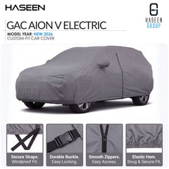 A gray custom-fit car cover shown on a car silhouette, with HASEEN branding and text for a Kia Grand Karnival model year 2021-2026 cover. Four feature callout panels at the bottom highlight secure straps, durable buckle, smooth zippers, and elastic hem.