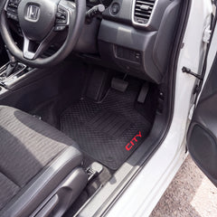 Black car floor mat with a diamond-embossed pattern and red 'CITY' text, shown installed inside a white vehicle near the open driver's side door.