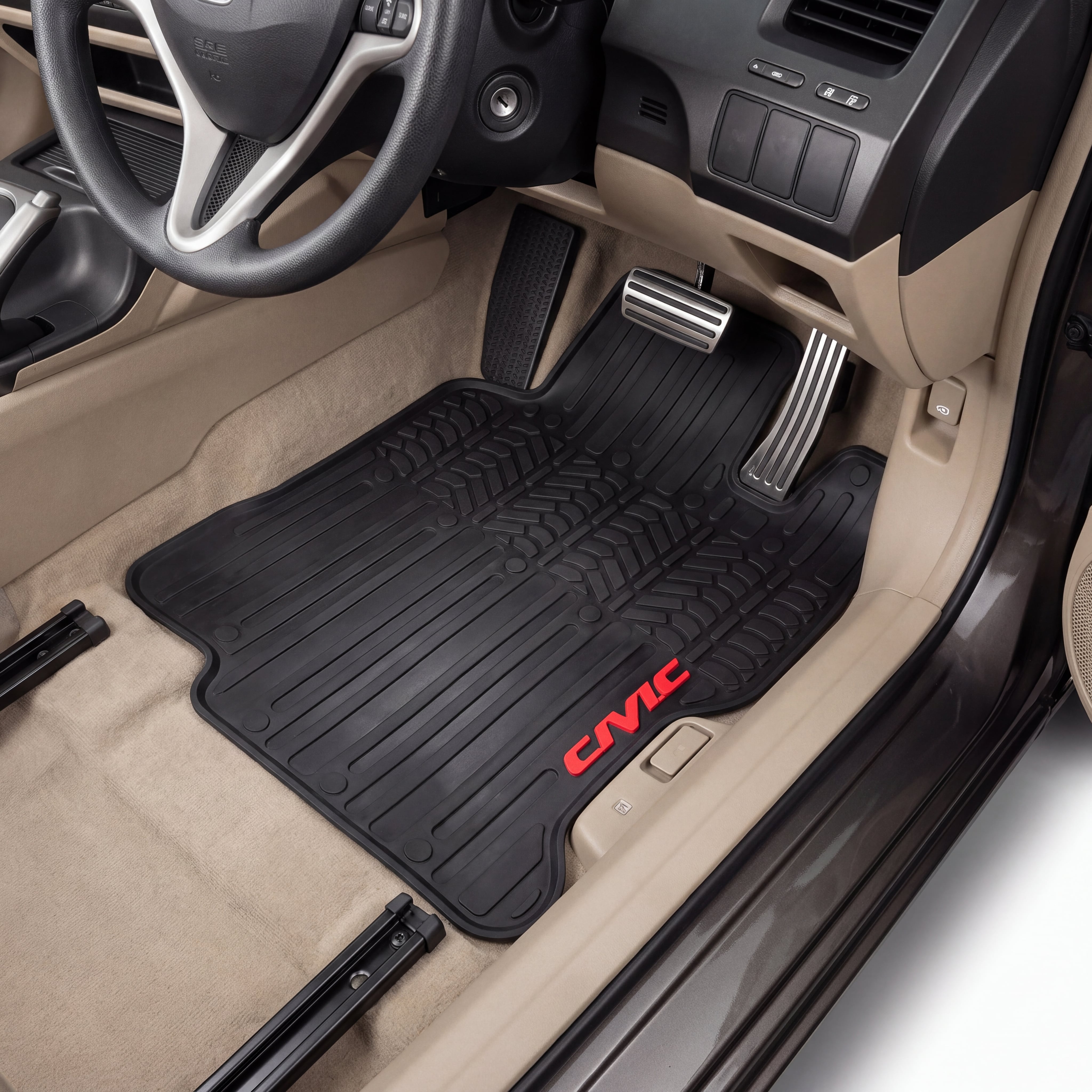 A pair of black rubber car floor mats with red 'CIVIC' branding, shown installed in the front of a beige Honda Civic interior.