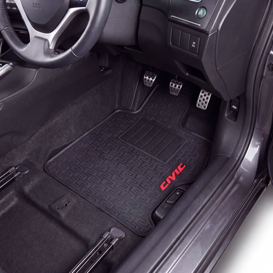 Black car floor mats installed in the driver and passenger footwells of a Honda Civic, with the red 'CIVIC' logo embroidered on the passenger mat.