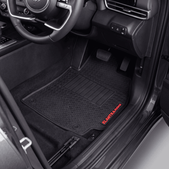 Black textured car floor mats installed in a vehicle's front cabin, with the driver's side mat showing a red ELANTAI-Pro logo near the threshold.