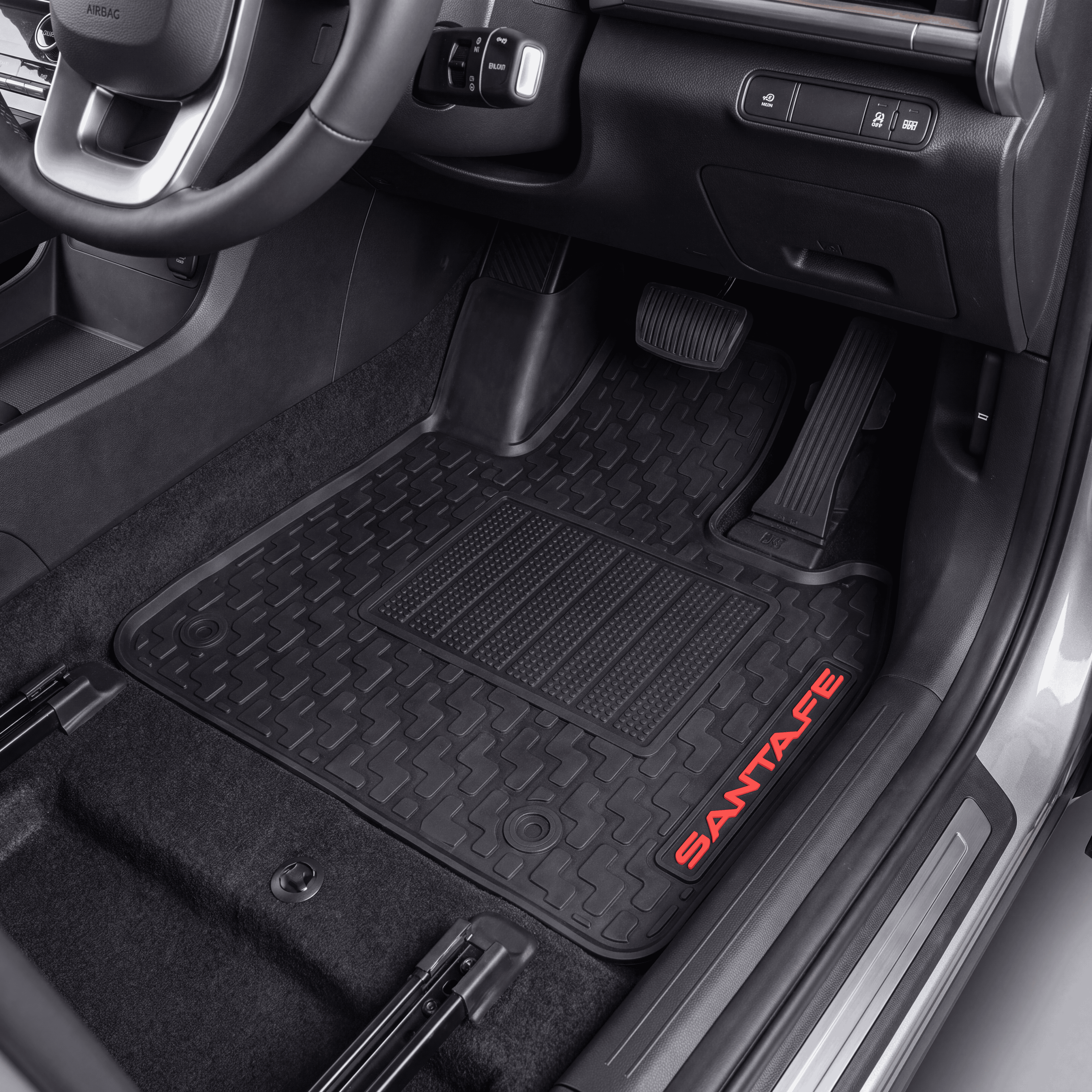 Black rubber car floor mats installed in a vehicle interior, with red SANTATE branding on the side of one mat.