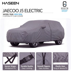 A gray custom-fit car cover shown on a white background, with the text 'JAECOO J5 ELECTRIC' and 'HASEEN GROUP' in the header. Four feature callout panels at the bottom highlight secure straps, durable buckle, smooth zippers, and elastic hem.
