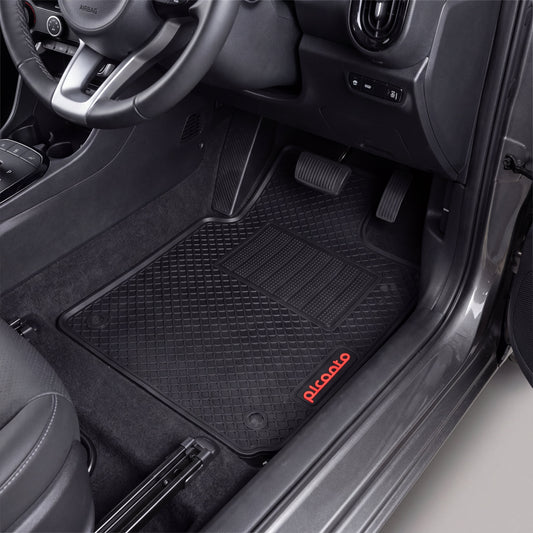Black rubber car floor mats installed in a vehicle's front footwell, with the driver's seat visible and the brand name 'Picoalo' printed in red on the lower right mat.