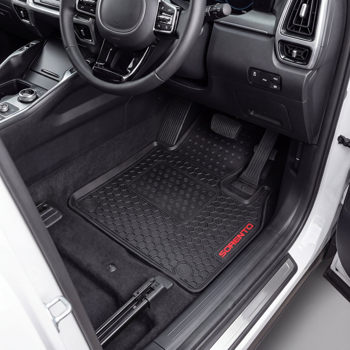 Black rubber car floor mats with a textured grip pattern and red 'SCORATO' branding, shown installed in a vehicle's footwell.