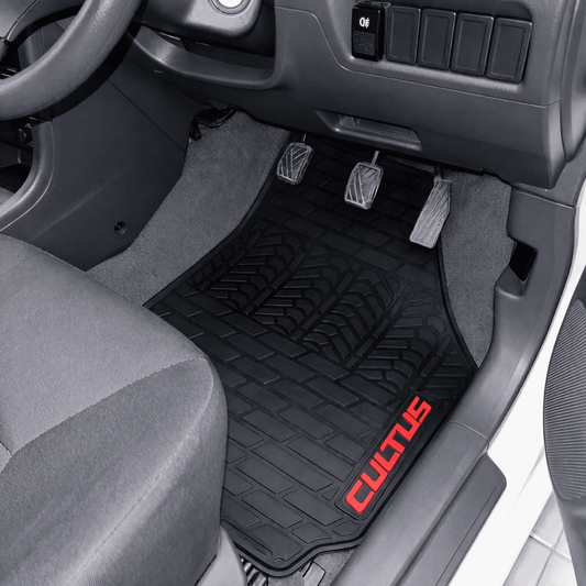 A black textured rubber car floor mat installed in the driver's footwell, with red 'CULOTUS' branding on the lower right corner. The mat is shown inside a vehicle cabin with gray carpet, pedals, and dashboard.