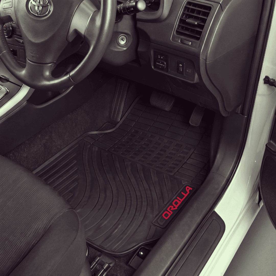 Black rubber car floor mats installed in the front cabin of a Toyota vehicle, with the driver's side mat showing a red 'ORILLA' logo near the bottom corner.