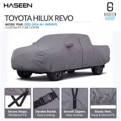 A gray custom-fit car cover shown on a Toyota Hilux Revo vehicle, with HASEEN branding and four feature callout panels at the bottom highlighting secure straps, durable buckle, smooth zippers, and elastic hem.