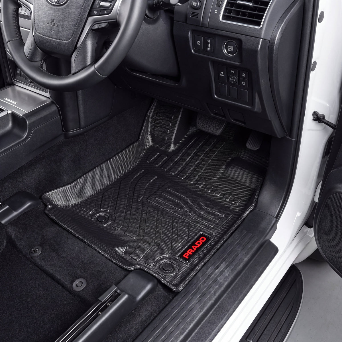 Haseen Toyota Prado 9D TPE car floor mats installed – black mats with red Prado logo in driver footwell, Pakistan