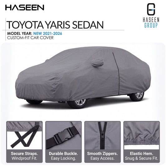 A gray car cover fitted over a Toyota Yaris sedan, shown on a white background with HASEEN branding and feature callout panels at the bottom describing secure straps, durable buckle, smooth zippers, and elastic hem.